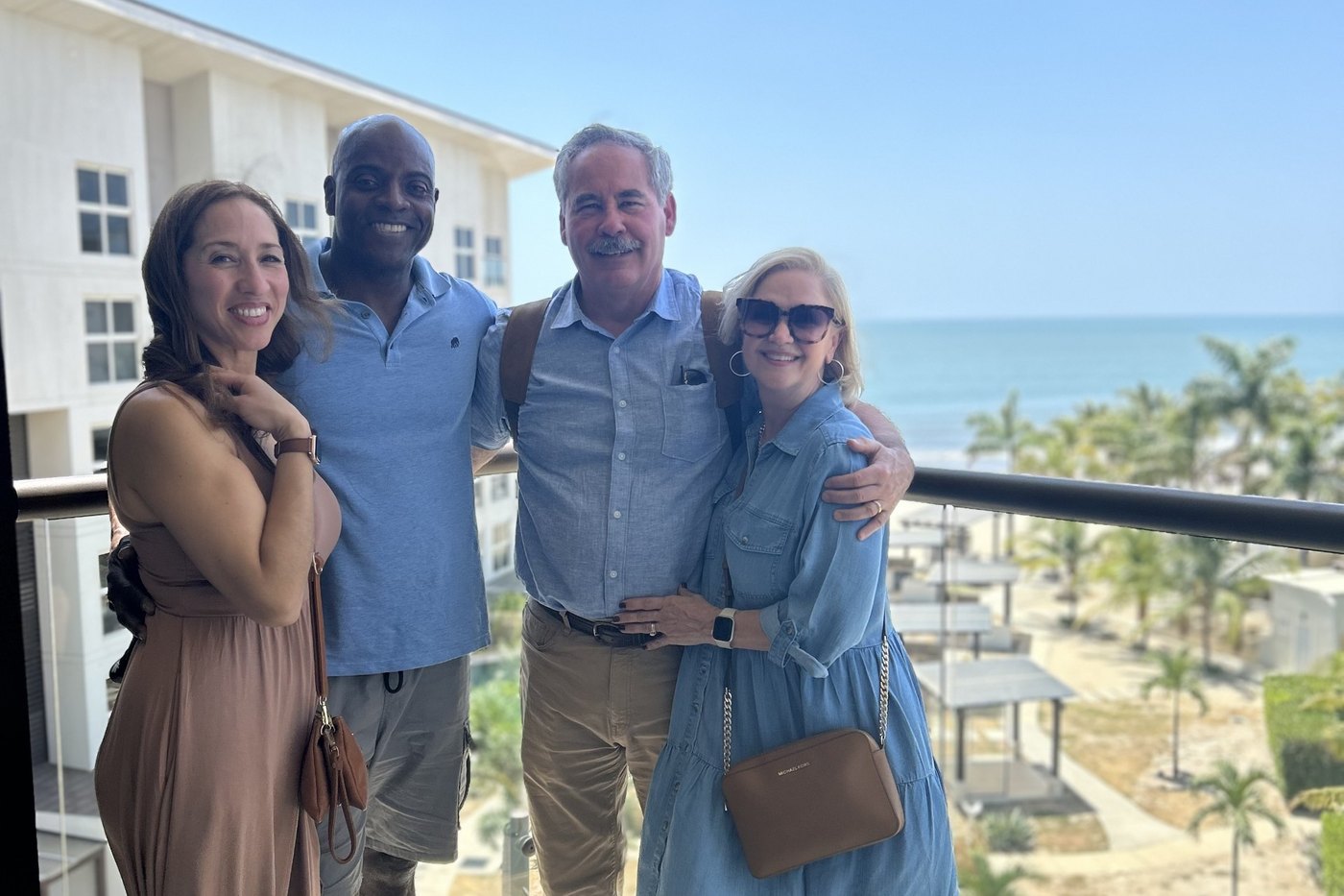 John Phillips with clients Robert and Vickie Turner on a balcony overlooking the beach at Playa Caracol, Panama